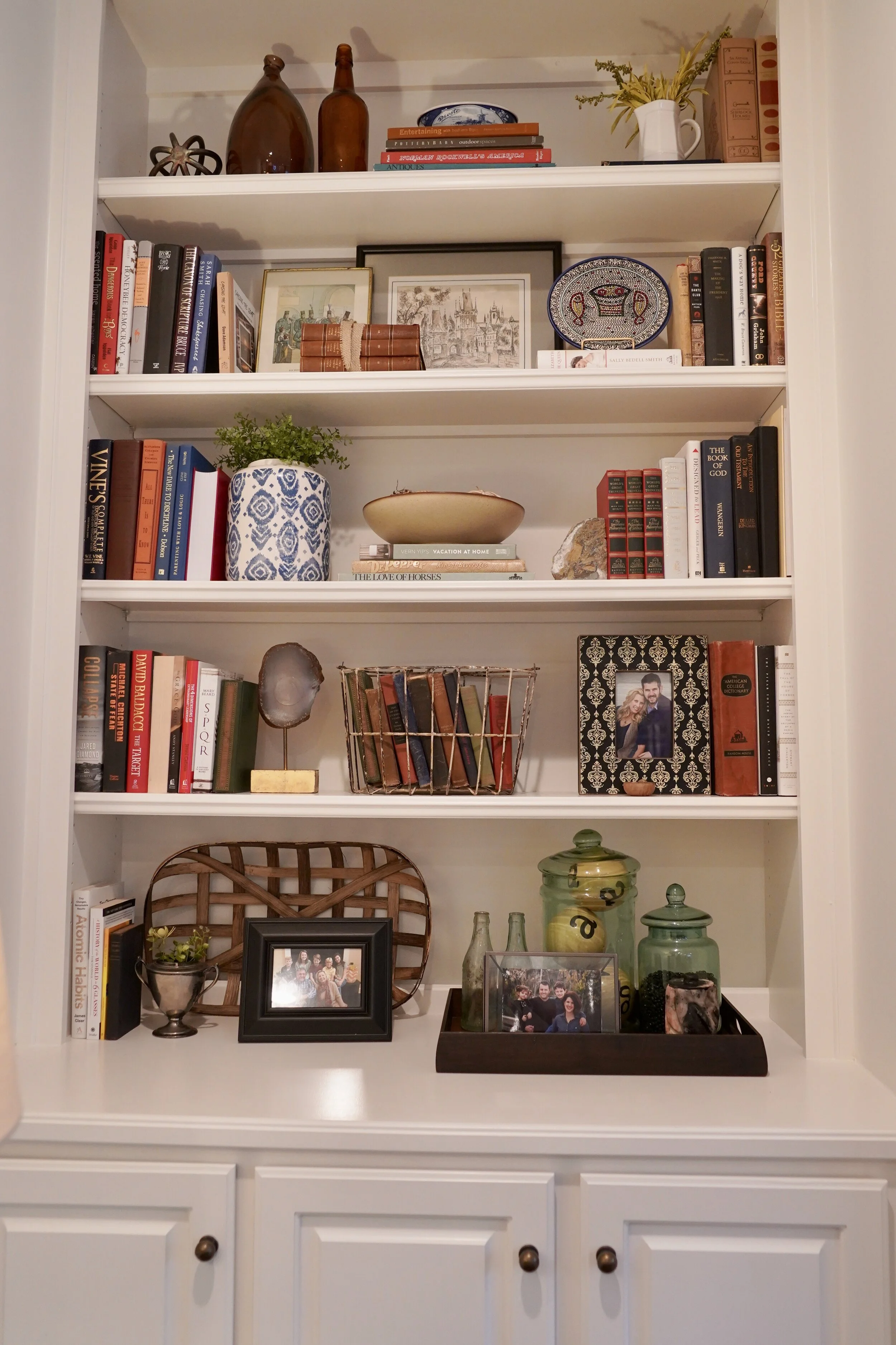 Built-in shelves styled with books, ceramics and greenery