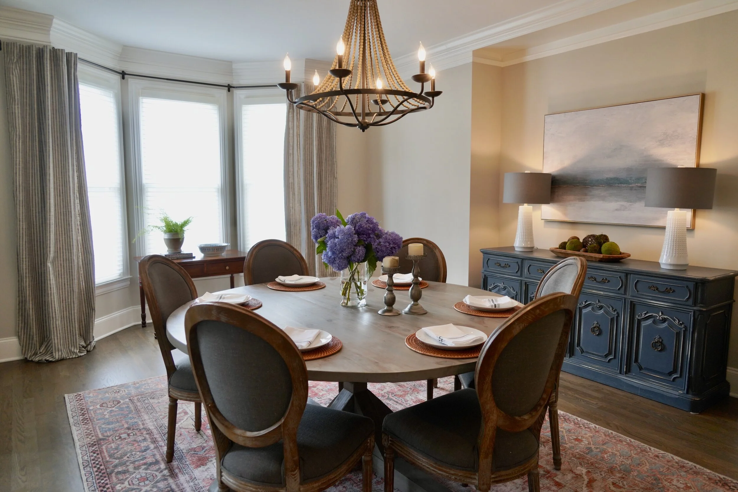 Dining room styled with layered linens and a centerpiece